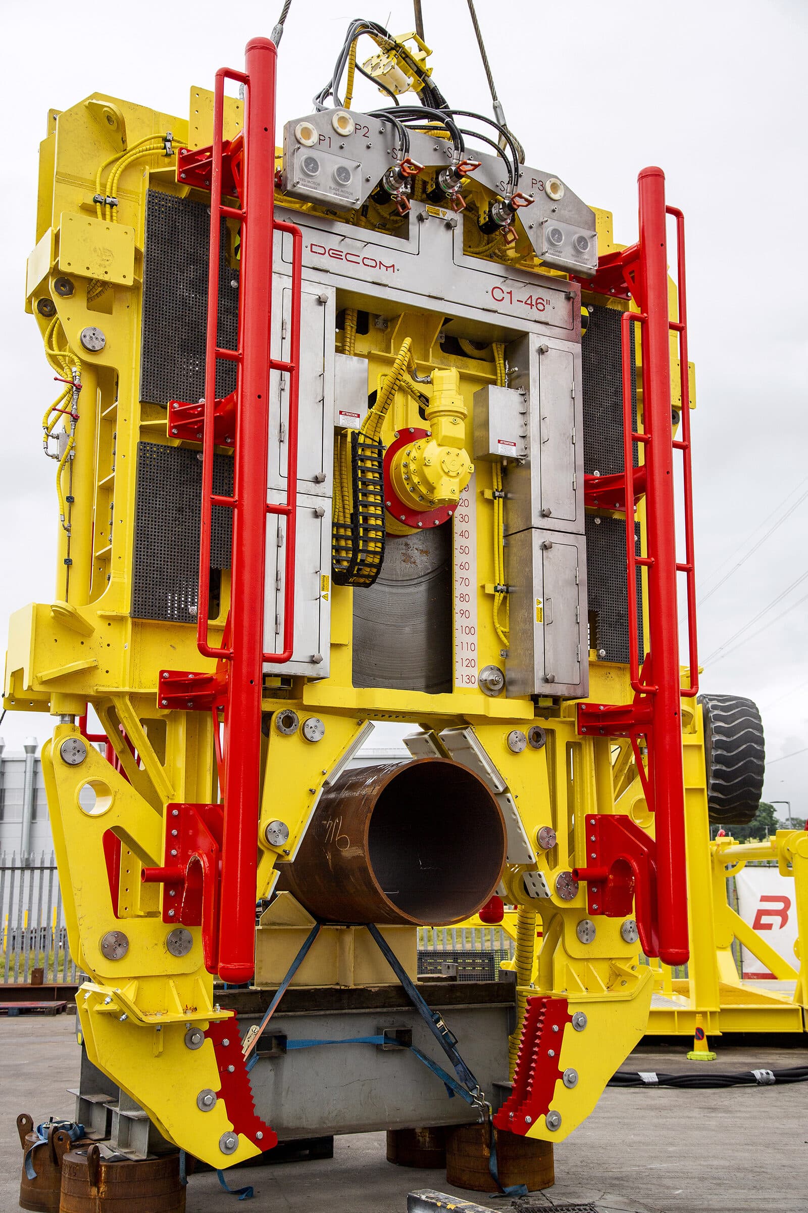 C1-46 Chopsaw front view with pipe loaded, crane rigging on yard